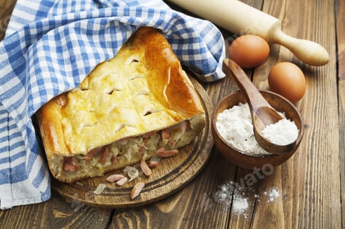 Preview: Pie With Cabbage And Sausages On The Table