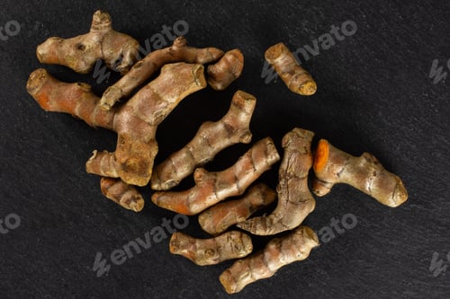 Preview: Lot Of Whole Fresh Bright Turmeric Rhizome Flatlay On Grey Stone