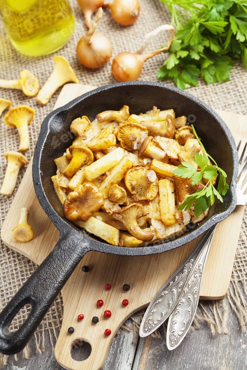 Preview: Fried Potatoes With Chanterelles In A Frying Pan On The Table