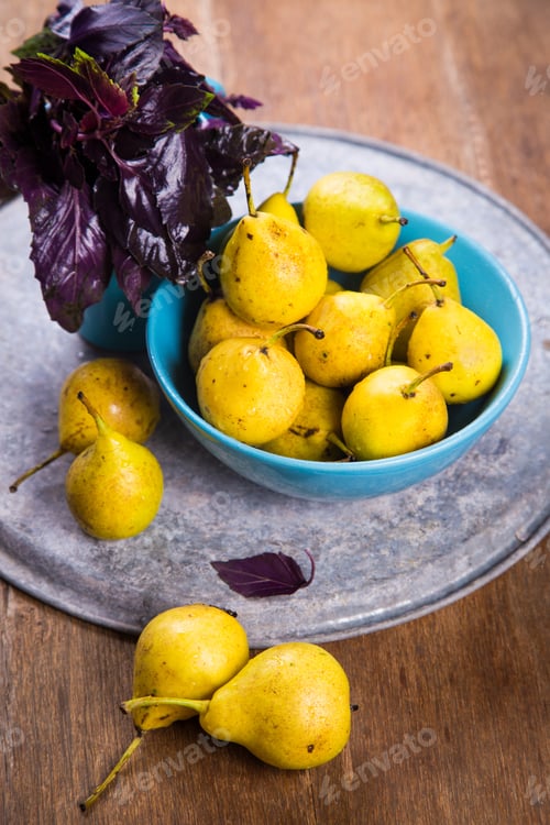 Preview: Some Raw Ripe Small Yellow Pears In Blue Dish On Wooden Background