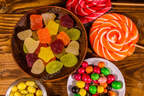 Preview: Different Sweet Candies On Rustic Wooden Table. Top View