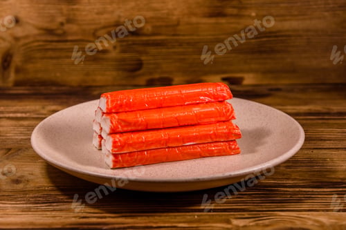 Preview: Ceramic Plate With Pile Of Crab Sticks On Wooden Table
