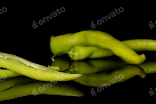 Preview: Group Of Two Whole Two Halves Of Hot Green Pepper Banana Isolated On Black Glass