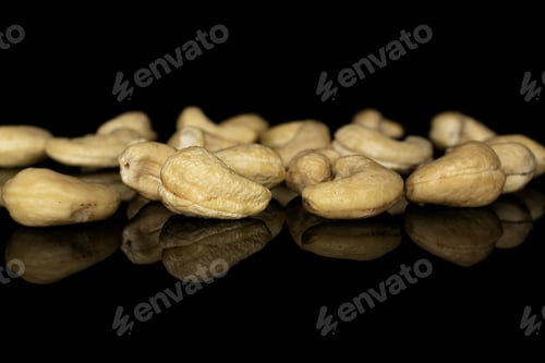 Preview: Lot Of Whole Brown Nut Cashew Heap Isolated On Black Glass