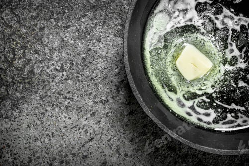 Preview: Butter In An Old Pan. On Rustic Background.