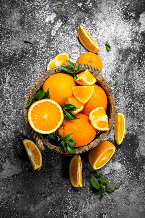 Preview: Fresh Oranges In A Wooden Bucket. On A Rustic Background.