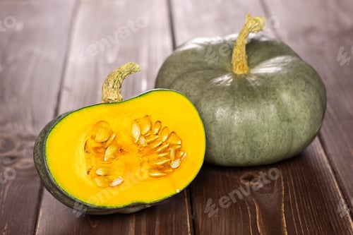 Preview: Group Of One Whole One Half Of Fresh Blue Grey Pumpkin Nagy Dobosi Variety On Brown Wood