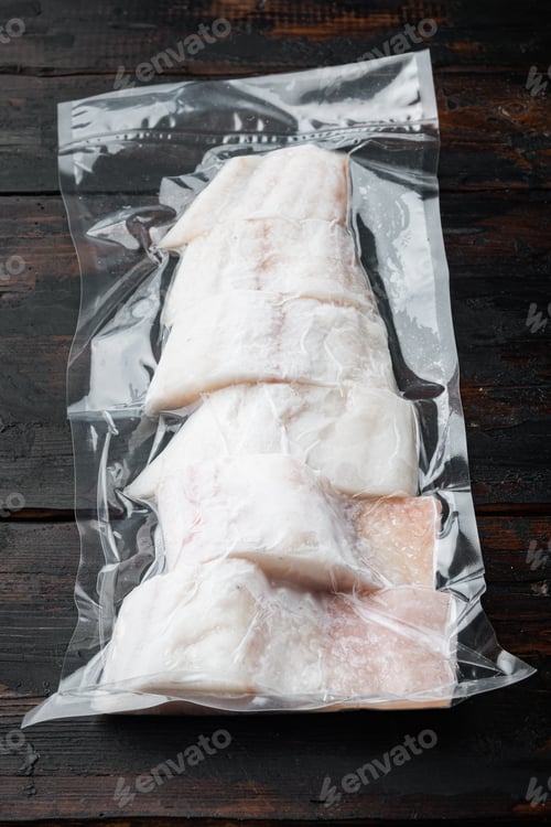 Preview: Raw Haddock Fish Skinless Plastic Vacuum Packaged, On Dark Wooden Background