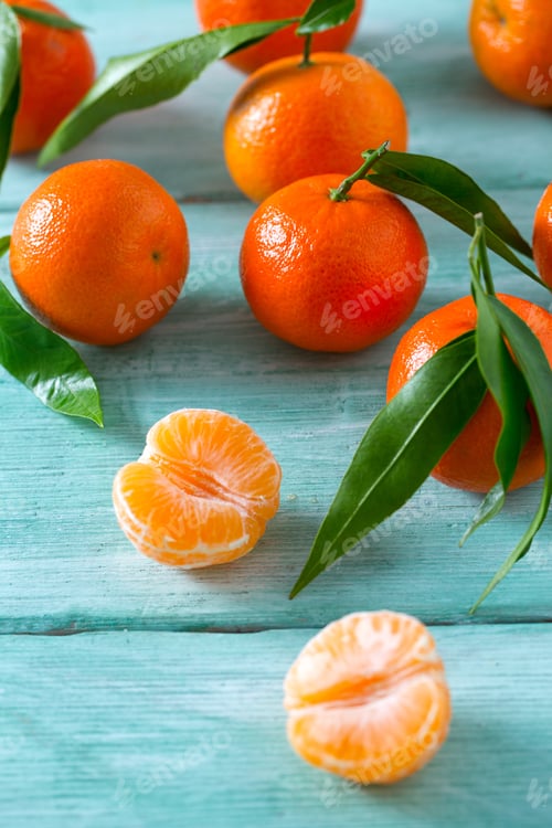 Preview: Tangerines With Green Leaves On Turquoise Wooden Background