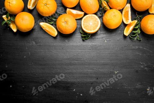 Preview: Fresh Oranges With Leaves. On The Black Chalkboard.