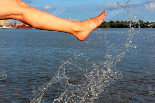 Preview: Cheerful Woman Kicking Her Feet In The Danube River. Girl Playing In The Water At The River