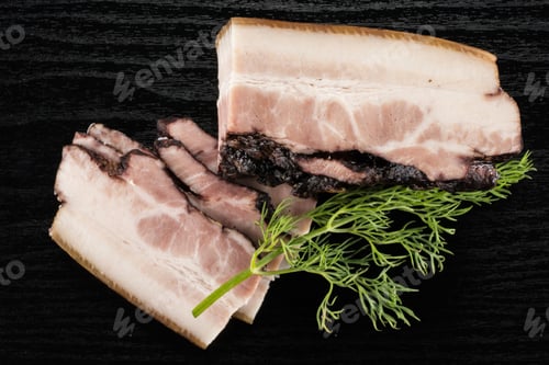 Preview: Group Of Three Slices One Piece Of English Bacon With A Sprig Of Dill Flatlay On Black Wood