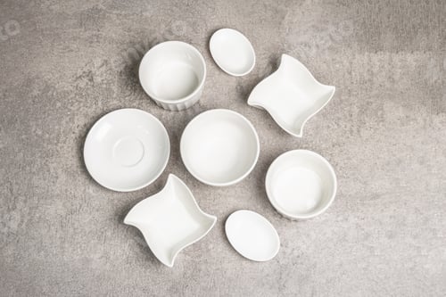 Preview: Assorted White Empty Bowls And Plates On A Stone Background. Different Ceramic Dishes And Kitchen