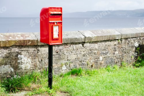 Preview: Red Post Box In Scottish Rural Location Brightly Lit Under Dark Sky