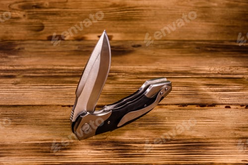 Preview: Opened Folding Knife On Rustic Wooden Table