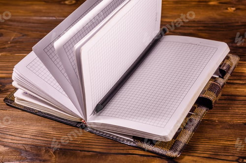 Preview: Opened Notepad And Pencil On Rustic Wooden Table