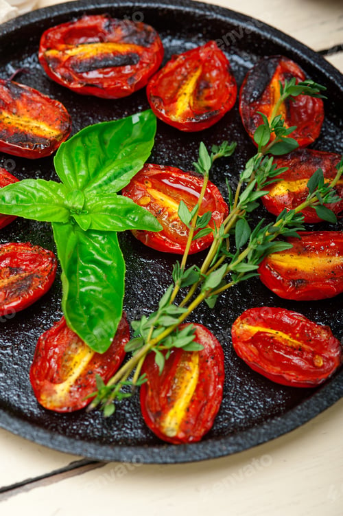 Preview: Oven Baked Cherry Tomatoes With Basil And Thyme On A Cast Iron Skillet