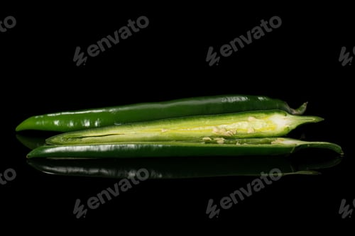 Preview: Group Of One Whole Two Halves Of Fresh Hot Pepper Isolated On Black Glass