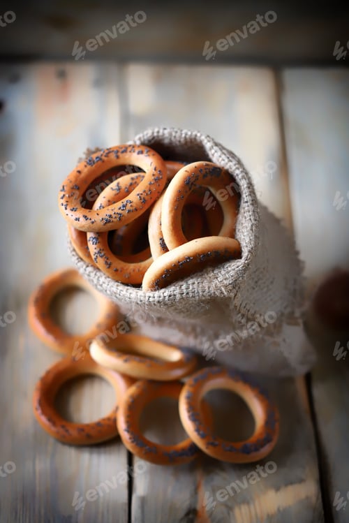 Preview: Selective Focus. Macro. Bagels With Poppy Seeds In A Bag On A Wooden Surface. Fresh Bagels With