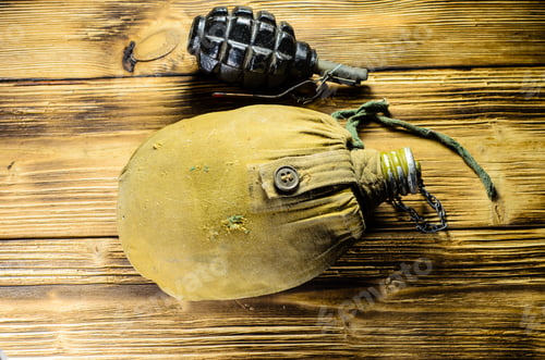 Preview: Army Flask In Rag Khaki Cover And Hand Grenade On Wooden Table