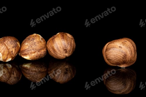 Preview: Lot Of Whole Tasty Brown Hazelnut In Row Isolated On Black Glass