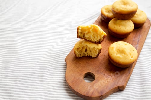 Preview: Homemade Cornbread Muffins On A Rustic Wooden Board, Side View. Copy Space.