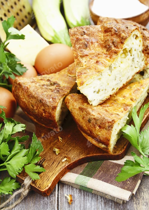 Preview: Pie With Zucchini, Cheese And Herbs On The Table