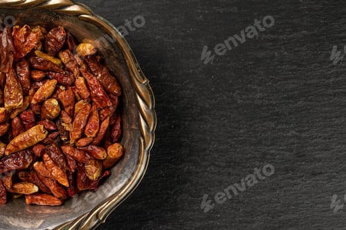 Preview: Lot Of Whole Dry Red Chili Pepper Peperoncino Copyspace Right In Old Iron Bowl Flatlay On Grey Stone