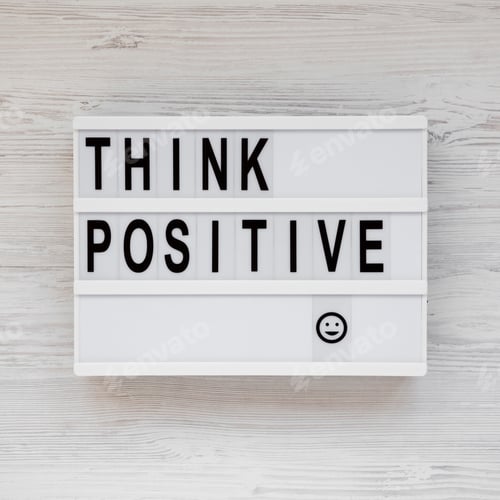Preview: 'Think Positive' Words On A Modern Board, Clipboard With Blank Sheet Of Paper On A White Wooden