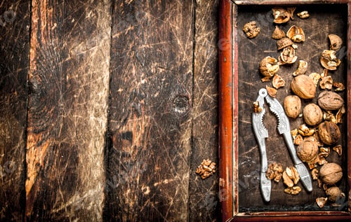 Preview: Walnuts With Nutcracker. On The Wooden Background.