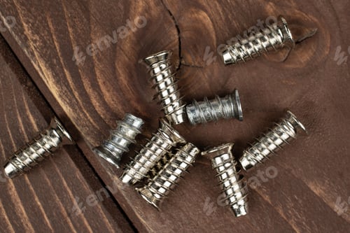 Preview: Group Of Nine Whole Metallic Glossy Bolt Flatlay On Brown Wood