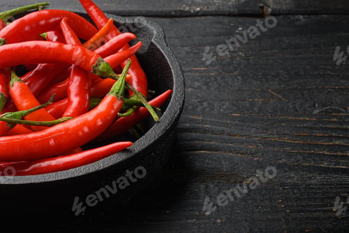 Preview: Hot Red Thai Pepper Set, On Black Wooden Table, With Copy Space For Text
