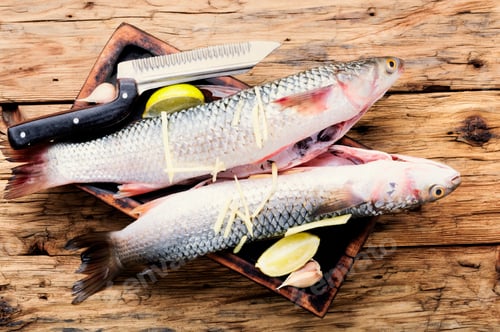Preview: Fresh Raw Sea Fish On Wooden Cutting Board
