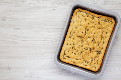 Preview: Home-Baked Rosemary Garlic Focaccia Bread On Baking Tray, Top View. Flat Lay, Overhead, From Above