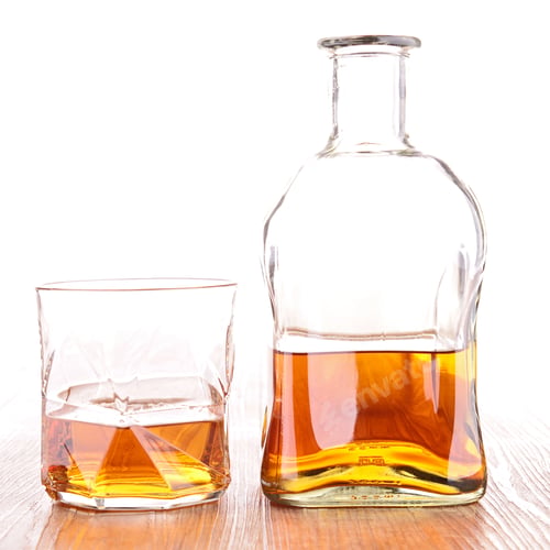 Whiskey Bottle and Glass on Wooden Table