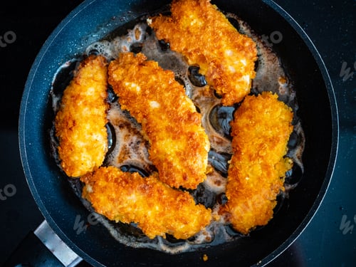 Preview: Breaded Chicken Breast Nuggets Frying In Pan