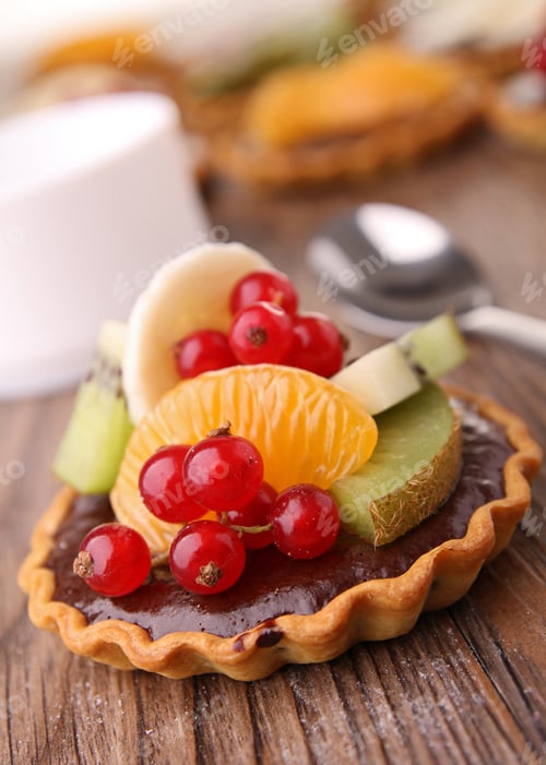 Chocolate Tart with Fresh Fruits on a Wooden Table