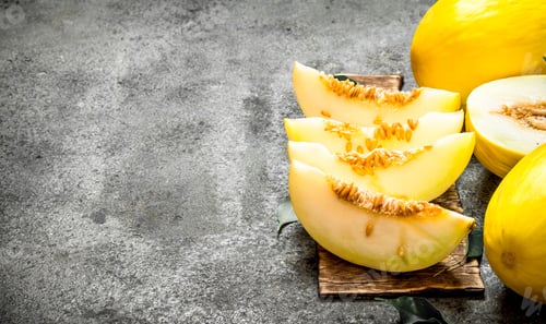 Preview: Ripe Reipe Melon . On A Rustic Background.