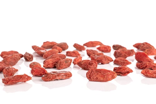 Preview: Pile of Red Goji Berries on White Surface