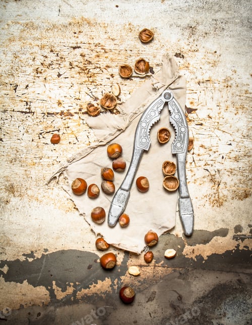 Preview: Hazelnuts With Nutcracker . On A Rustic Background.