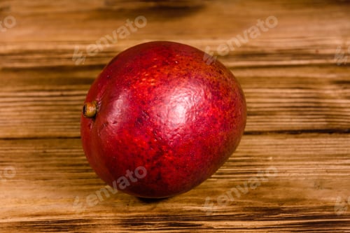 Preview: Whole Red Mango Fruit On Rustic Wooden Table