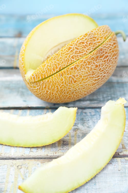 Preview: One Cut Fresh Ripe Melon On A Wooden Background
