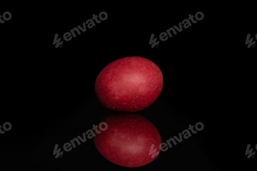 Preview: One Whole Red Sugared Nut Dragee Isolated On Black Glass