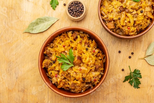 Preview: Stewed (Braised) Cabbage Served On Ethnic Ceramic Bowl. Traditional Polish Bigos With Meat