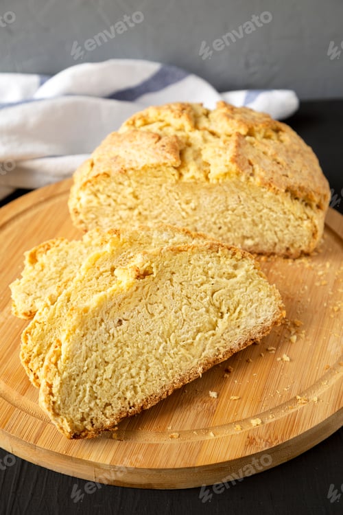 Preview: Homemade Irish Soda Bread On A Bamboo Board On A Black Background, Low Angle View.