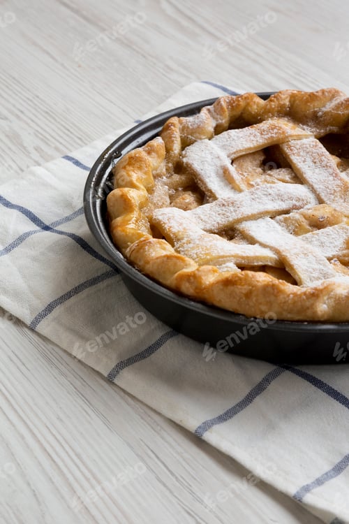 Preview: Home-Baked Apple Pie On Cloth On A White Wooden Surface, Side View.