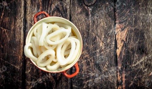 Preview: Rings Of Sea Squid In A Bowl. On A Wooden Background.