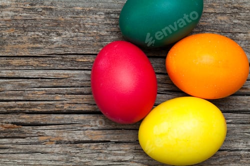 Preview: Brightly Colored Easter Eggs on Rustic Wood Background