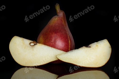 Preview: Group Of One Whole Two Slices Of Fresh Dark Red Pear Anjou Isolated On Black Glass