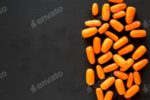 Preview: Fresh Baby Carrots On A Black Background, Top View. Flat Lay, Overhead, From Above. Copy Space.